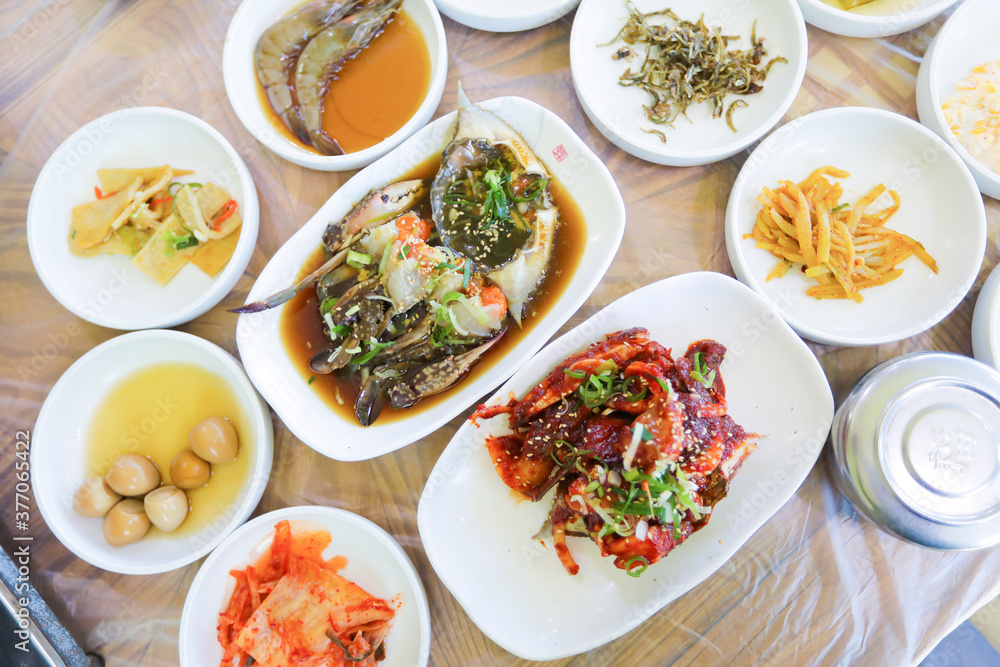 Korean traditional food, soy sauce marinated crab with a lot of side dishes