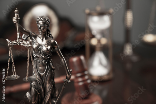 Lawyers office concept. Law symbols composition: Themis sculpture, gavel and scale.