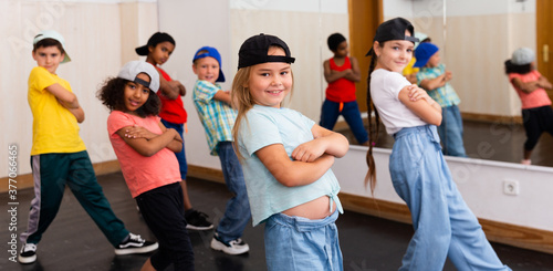 Positive girls and boys training hip hop in dance studio, dance classes for kids © JackF