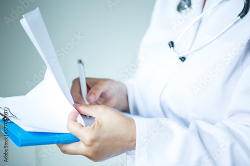 Healthcare - doctor with papers in hand.