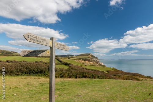 Фотография Close up of a sign post pointing toward Golden Cap mountain with Golden Cap moun