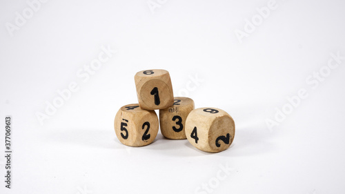 Four wooden dice on white background