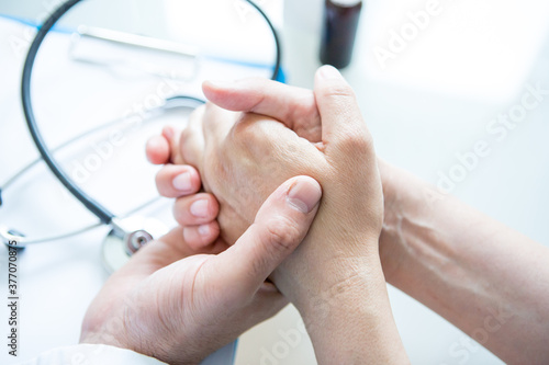 Healthcare -doctor conforming patient. Close-up of hands.