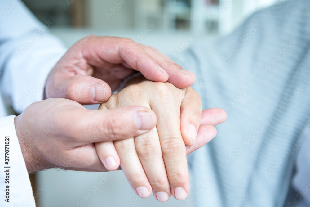 Doctor conforming patient - close-up of hands.