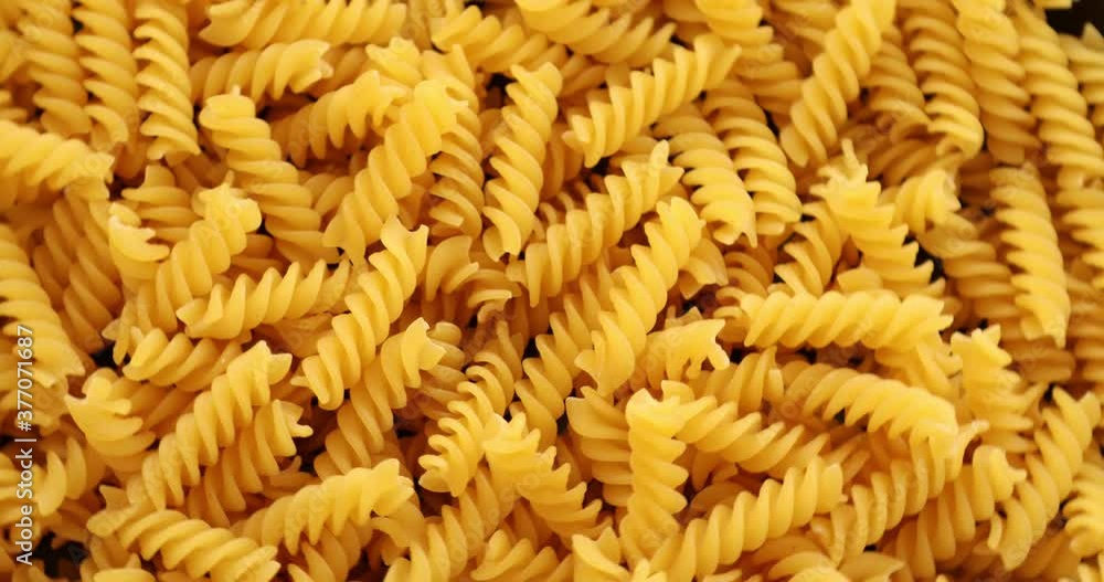Heap of rotating fusilli pasta on plate closeup Heap of rotating fusilli pasta on plate closeup