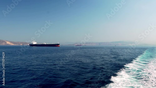 Wide shot of Argosaronikos sea at Greece, taken from ferry boat traveling, tanker ships in the frame 4K photo