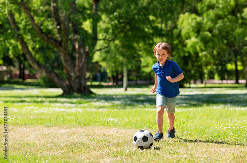 Canvas Print childhood, leisure games and people concept - happy little boy with ball playing