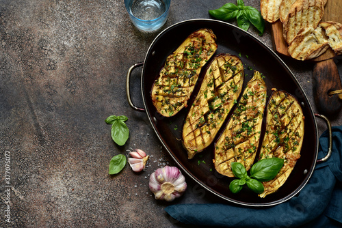 Grilled spicy eggplant in a skillet pan. Top view with copy space.