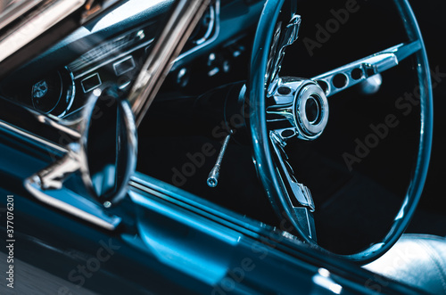 Vintage car dashboard. Retro muscle car interior. Steering wheel detail.