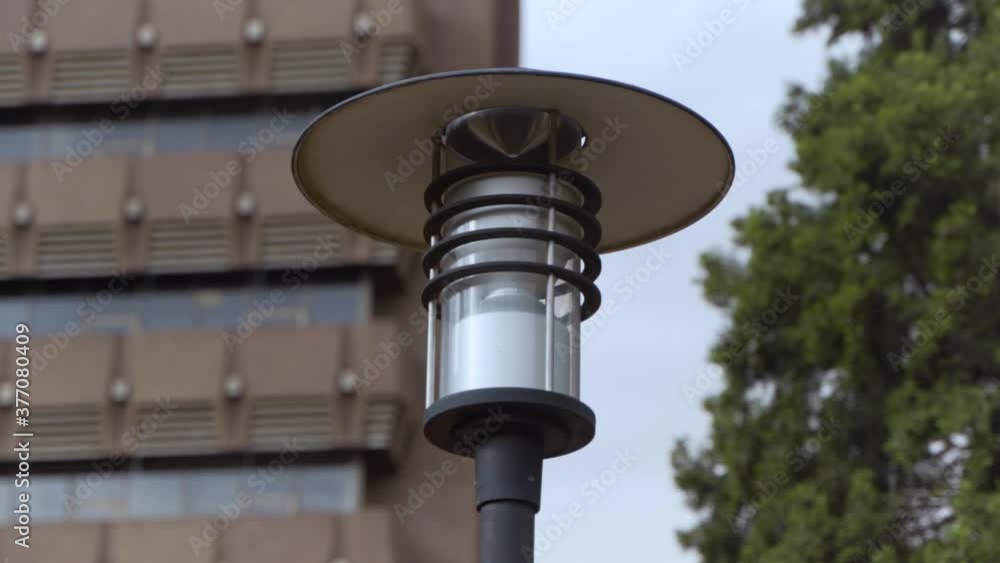 Lamp post in front of big building close Lamp post in front of big building close