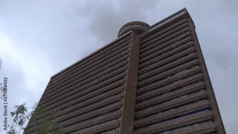 Imposing building on cloudy day low angle Imposing building on cloudy day low angle