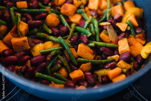 plant-based food, mixed vegetables getting sauteed in pan on stove