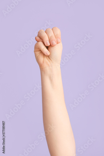 Hand showing letter M on color background. Sign language alphabet