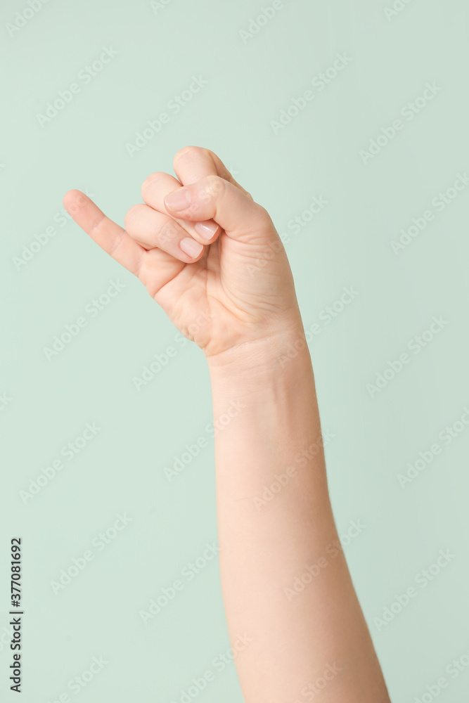 Hand showing letter J on color background. Sign language alphabet Hand showing letter J on color background. Sign language alphabet