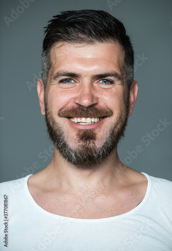 Happy man smile face. Barber with long beard and moustache in barbershop. Bearded man. Positive human facial expressions and emotions.