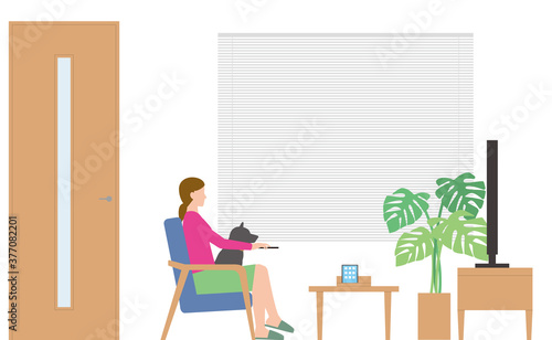 住宅。リビングでテレビを見る女性