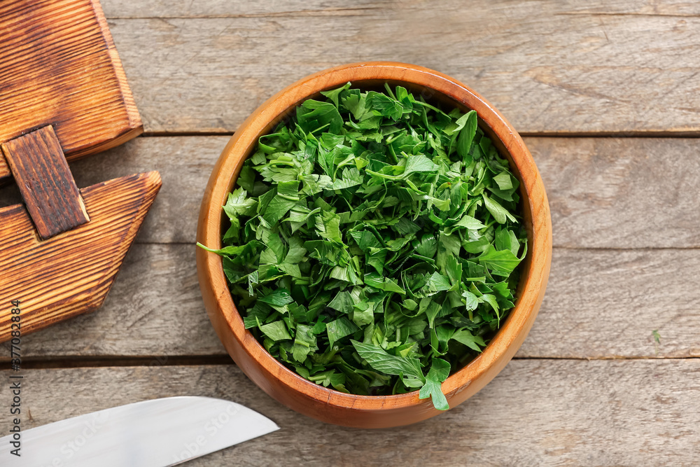 Bowl with fresh parsley on wooden table Bowl with fresh parsley on wooden table