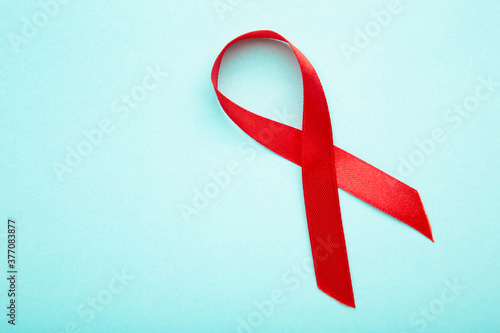 Aids awareness red ribbon on blue background