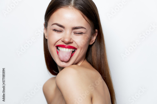 Woman portrait Naked shoulders gaiety closed eyes showing tongue bare shoulders 