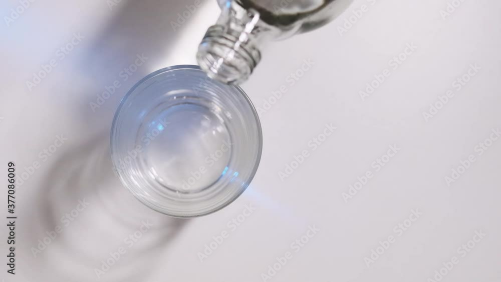 pouring mineral water into glass from bottle pouring mineral water into glass from bottle