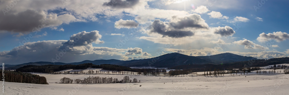 Panoramic winter czech landscape with hill and snow field