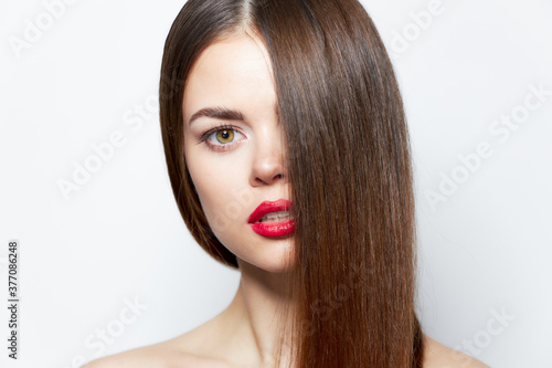Woman portrait Looking forward red lips hair covering her face clear skin 