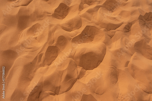 Hot red sand creates a natural texture carved by wind - Coral Pink Sand Dunes State Park, UT - USA