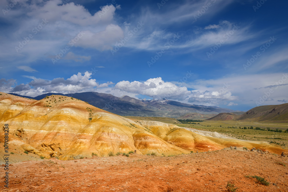 Amazing natural phenomenon-Martian landscapes in the Altai mountains. Multicolored rocks against a blue sky with white clouds. Futuristic panoramic picture, background image. Mars.