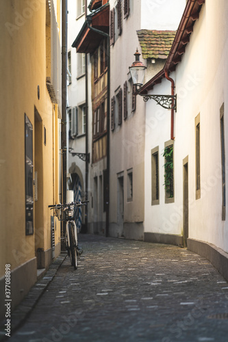 A narrow alley in the old town with a parked bike