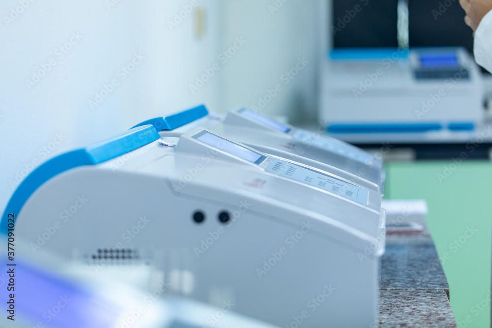 Sample analysis using Spectrophotometer for lab experiments. Stock Photo Adobe Stock