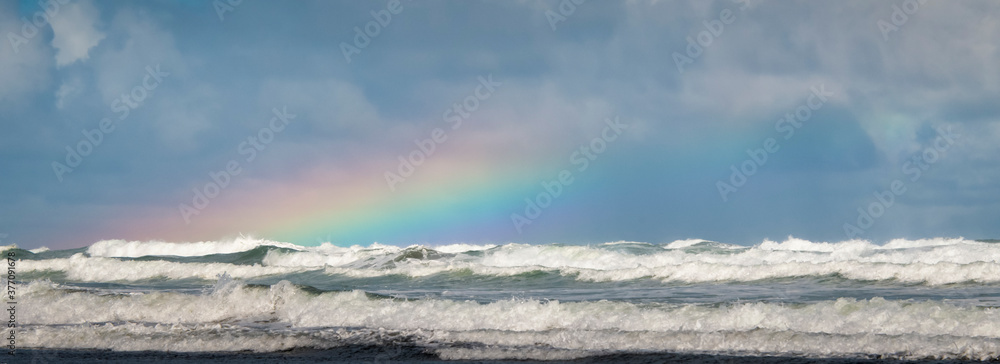 Rainbows and waves at Piha beach, Waitakere, Auckland