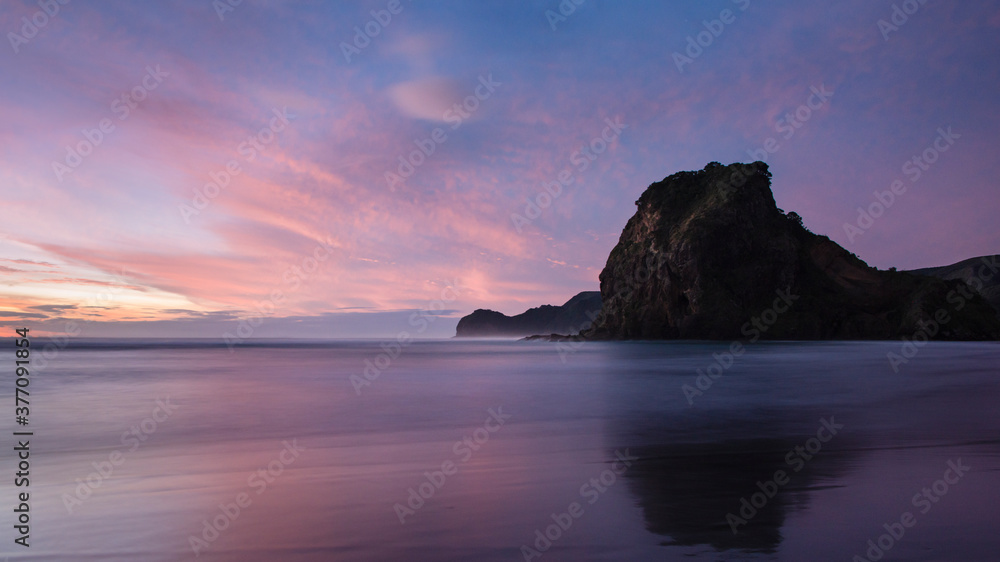 Lion rock of Piha beach at sunset, Waitakere, Auckland