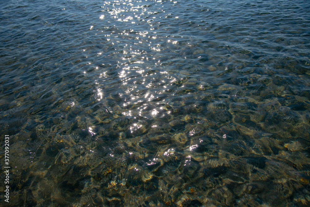 Full frame transparent sea water, illuminated by the sun.