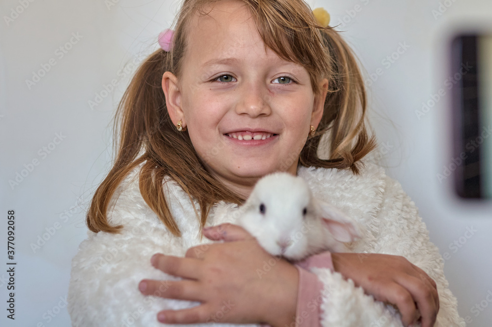 blonde girl with a white rabbit in her arms blonde girl with a white rabbit in her arms
