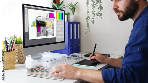 Graphic designer working with computer and graphic tablet