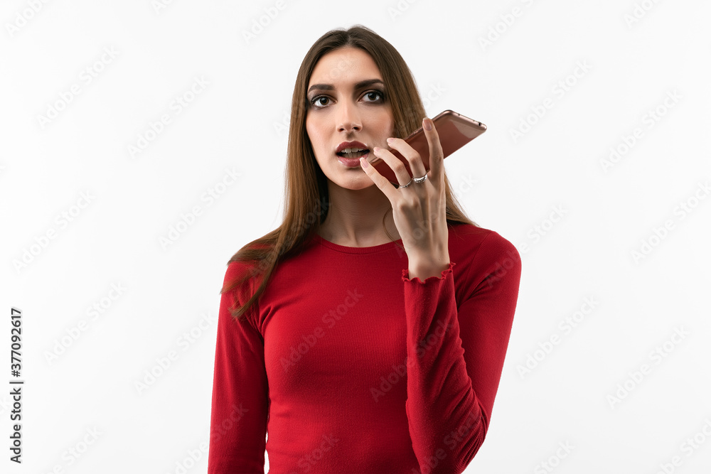 Young woman with long chestnut hair using mobile phone. Studio shot, white background, isolated Young woman with long chestnut hair using mobile phone. Studio shot, white background, isolated