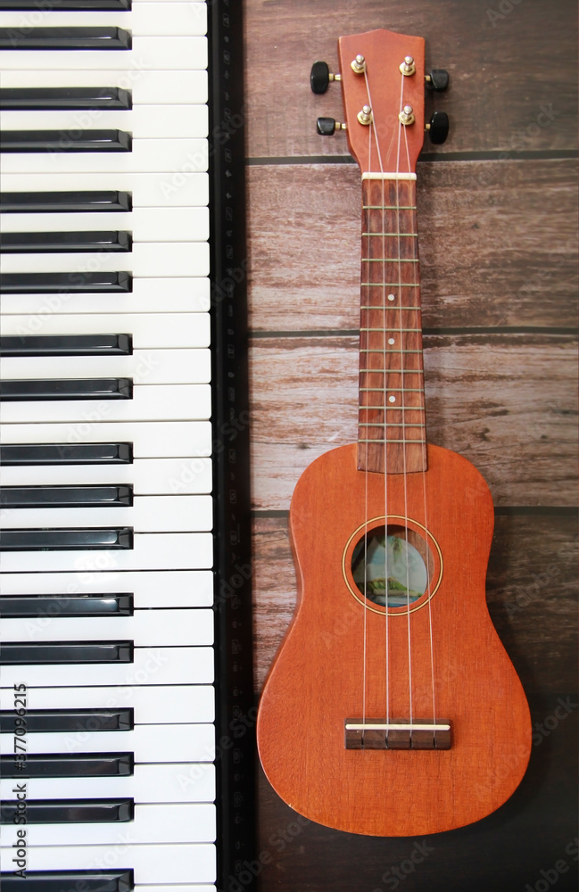 Fototapeta premium white black piano keys and guitar with a strings