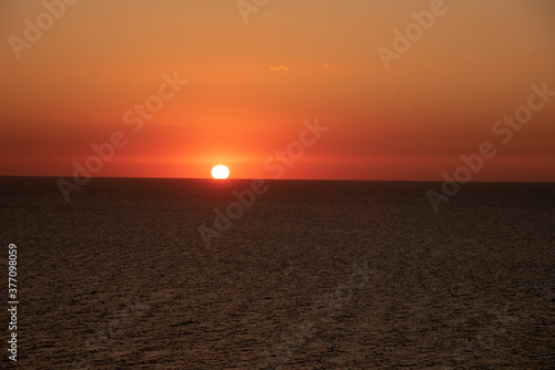 Bright red sunset over the sea. Summer landscape.
