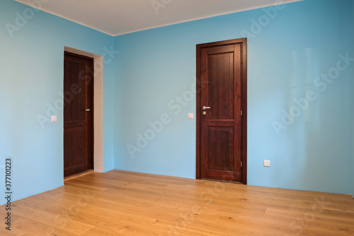 New home construction interior room with wooden floors and wooden doors
