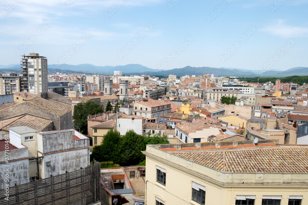 The beautiful cityscape, great cathedral and the red roofs of the medieval city of Girona, Spain