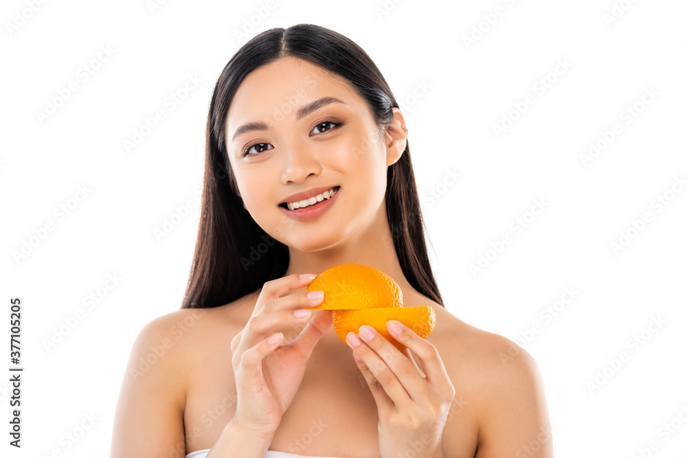 nude asian woman looking at camera while holding cut orange isolated on white nude asian woman looking at camera while holding cut orange isolated on white
