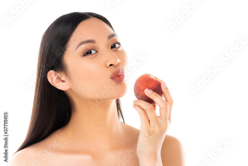 nude asian woman making duck face while holding whole peach isolated on white