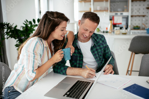 Husband and wife preparing bills to pay. Young couple having financial problems...