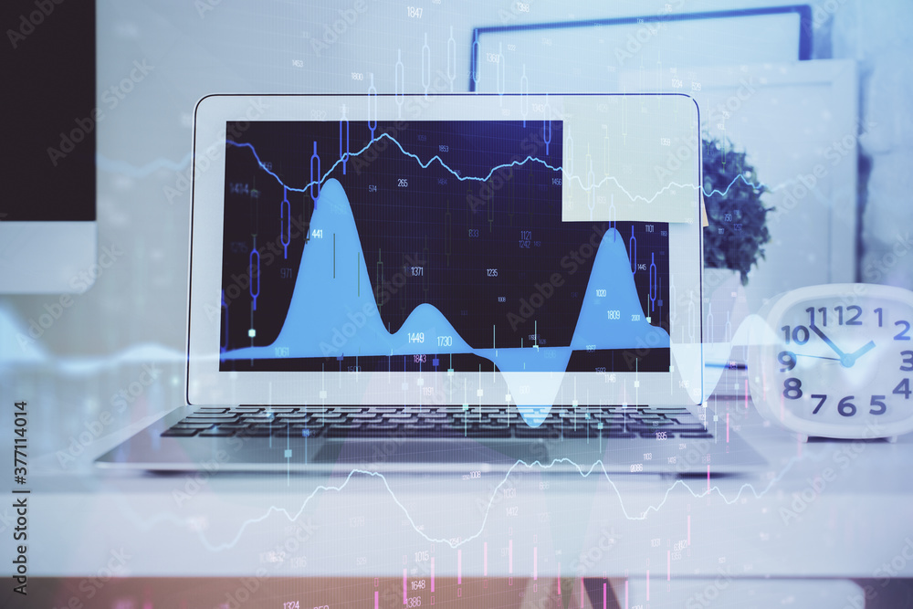 Stock market chart hologram drawn on personal computer background. Double exposure. Concept of investment. Stock market chart hologram drawn on personal computer background. Double exposure. Concept of investment.