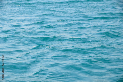 Blue sea water surface with ripples and waves