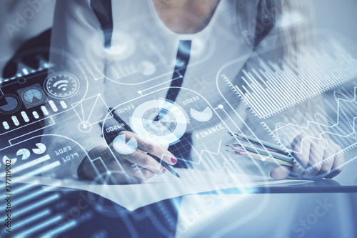 Technology theme hologram over woman's hands taking notes background. Concept of Tech. Double exposure