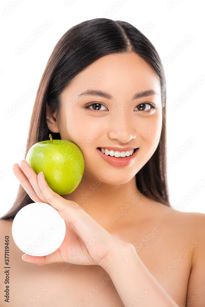 naked asian woman holding ripe green apple and cosmetic cream near face isolated on white naked asian woman holding ripe green apple and cosmetic cream near face isolated on white