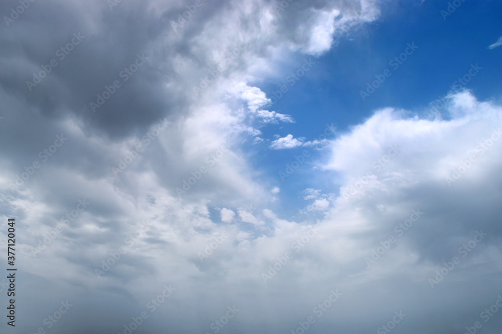 Stormy clouds background with a part of blue sky