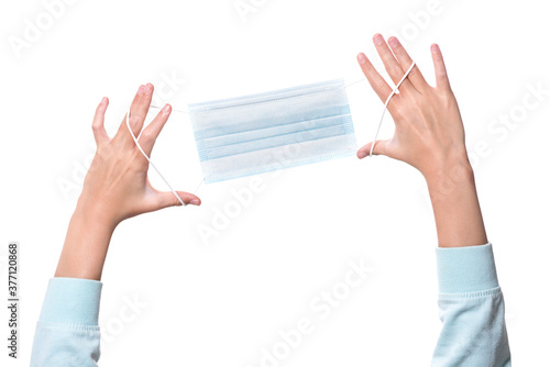 child's hands holding a mask