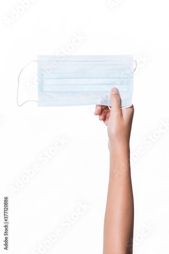 child's hand holding a mask